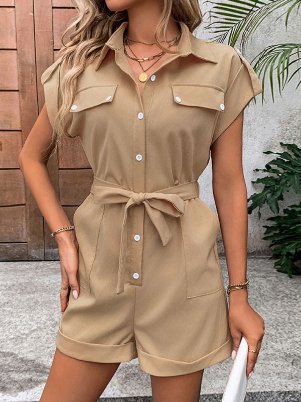 Model walking outdoors in The Leonila Playsuit in camel with tie-up waist and short sleeves.