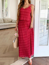 A model wearing the Marbella Skirt and Top Two Piece Set in red, showcasing its elegant texture.