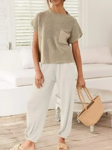 Front view of model wearing The Marla Set with hands in white pants' pockets.