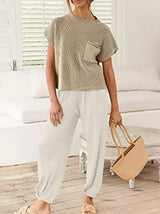 Front view of model wearing The Marla Set with hands in white pants' pockets.
