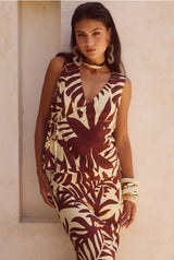 Woman standing in the Matelo Vest in Brown styled with matching skirt in a summer setting.