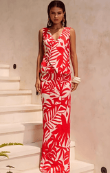 A model wearing the Matelo Vest and Maxi Skirt Two Piece Set in red, featuring a tropical white leaf print.