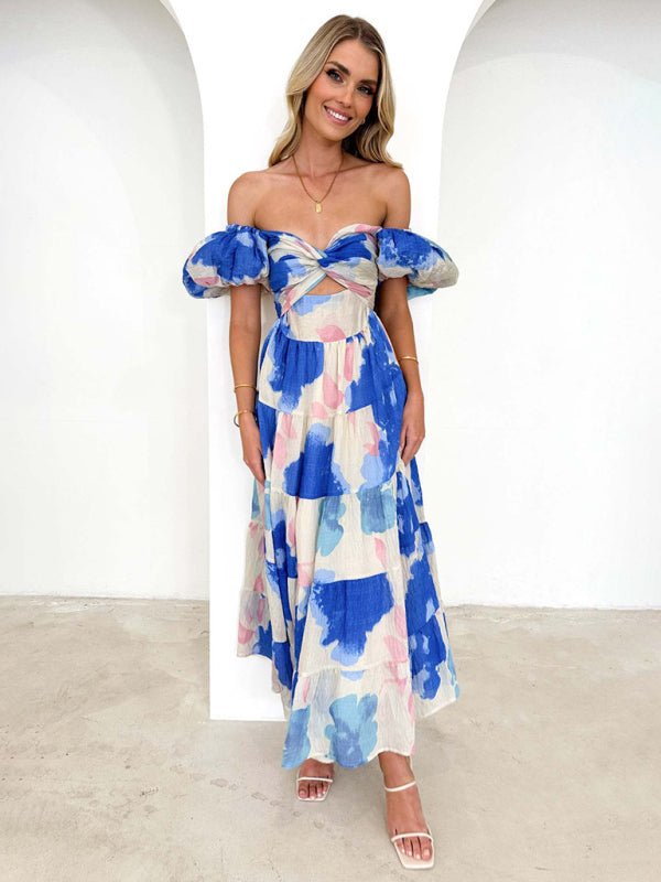 Woman wearing a blue and white floral dress against a white background