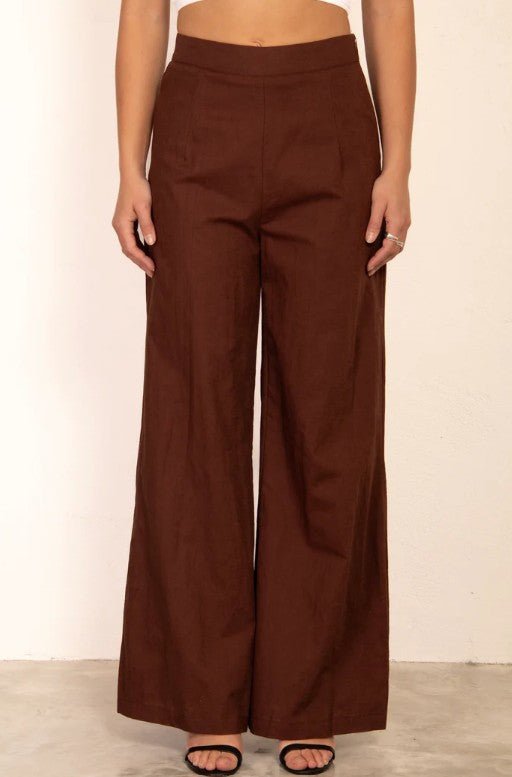 Brown wide-leg pants worn by a person on a plain background