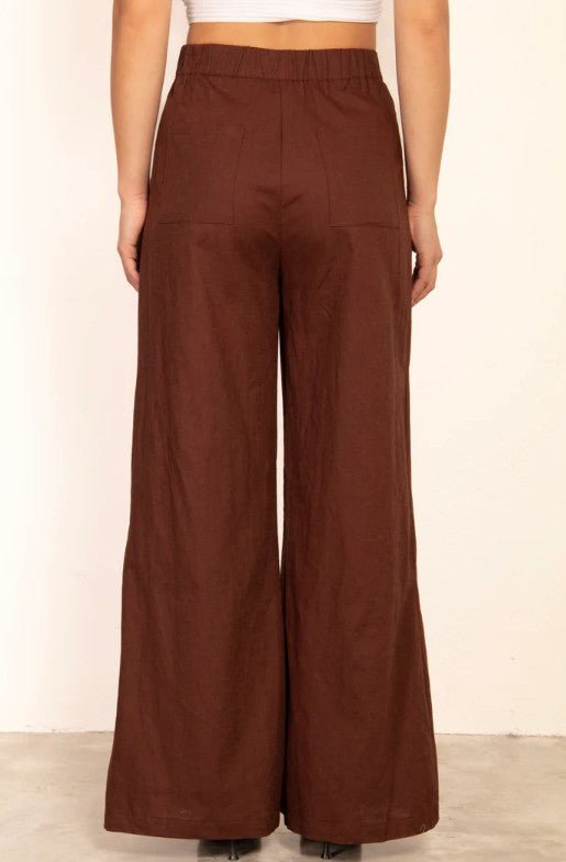 Brown wide-leg pants worn by a person on a plain background