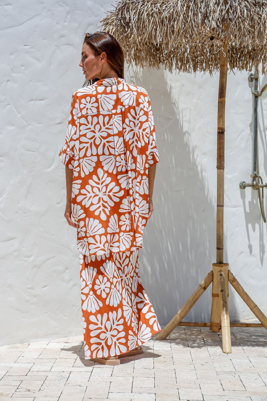 Model standing in full Nahla Maxi Skirt set with matching slouch shirt, styled in sun-drenched resort setting.