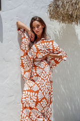 Nahla shirt styled open with hands on hips, against white wall