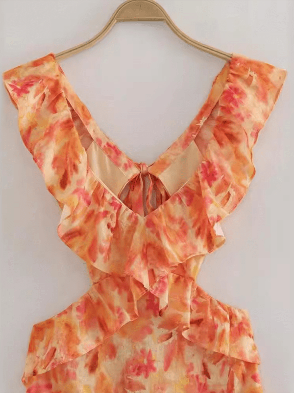 Floral-patterned dress on a hanger against a white background