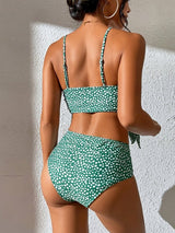 Back view of green polka dot bikini showing adjustable straps and tie feature.