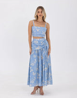 Model wearing the Ralene Skirt and Top Set in blue floral print, front view.