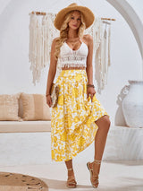 Model posing in yellow Summer Love Skirt, smiling in a relaxed beach-inspired setting.