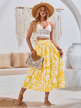 Yellow floral Summer Love Skirt worn with white crop top and sandals, perfect for summer outings.