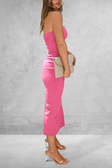 Woman wearing a pink strapless dress against a gray background