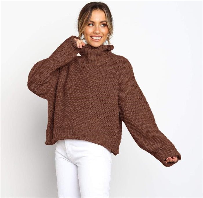 Woman wearing the Tamra Oversized Jumper in Chocolate Brown, styled with white pants.