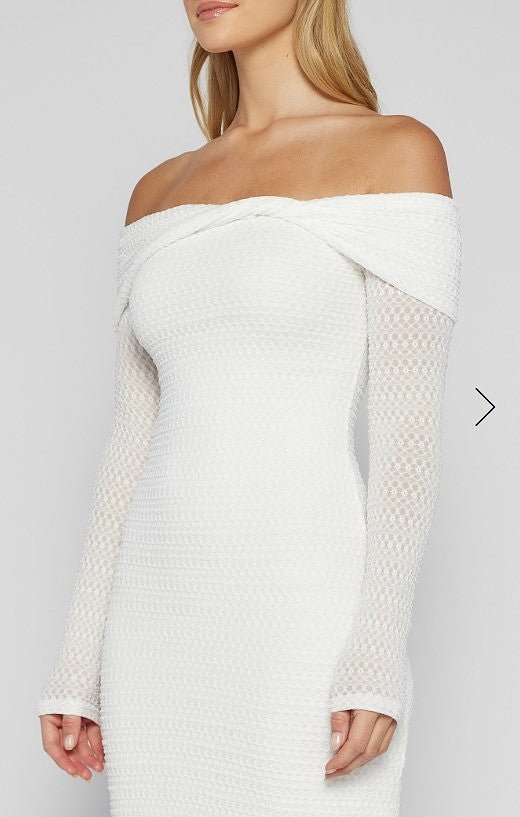 White off-shoulder dress with textured sleeves on a plain background