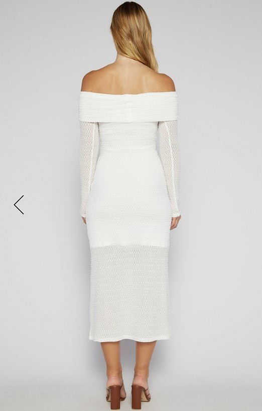 White off-shoulder dress worn by a person on a plain background