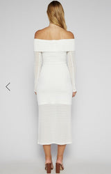 White off-shoulder dress worn by a person on a plain background