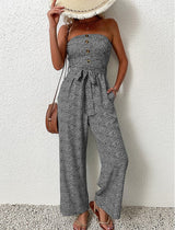 Front view of The Janisa Jumpsuit in black, showing the strapless cut and subtle waistline detailing.