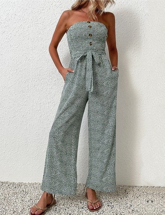 A model poses in The Janisa Jumpsuit in green, showcasing the relaxed wide-leg fit and shirred bodice with a natural pose.