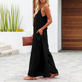 Side view of The Harlot Jumpsuit in black, showcasing relaxed fit and spaghetti straps.