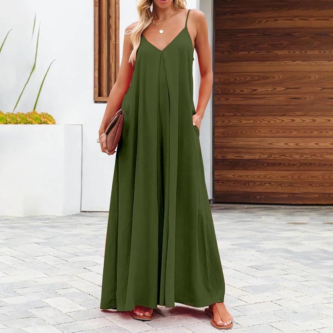 Full-length view of The Harlot Jumpsuit in green, styled with neutral accessories for summer.