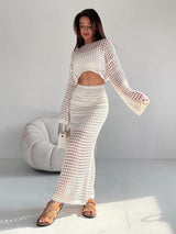 Side view of white two piece set with high-waisted maxi skirt and crop top