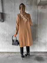 Willow Luxe Long Coat in camel – three-quarter angle, worn with black pants