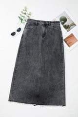 Flat lay of the Zuri Maxi Denim Skirt in Black styled with sunglasses and a phone case.