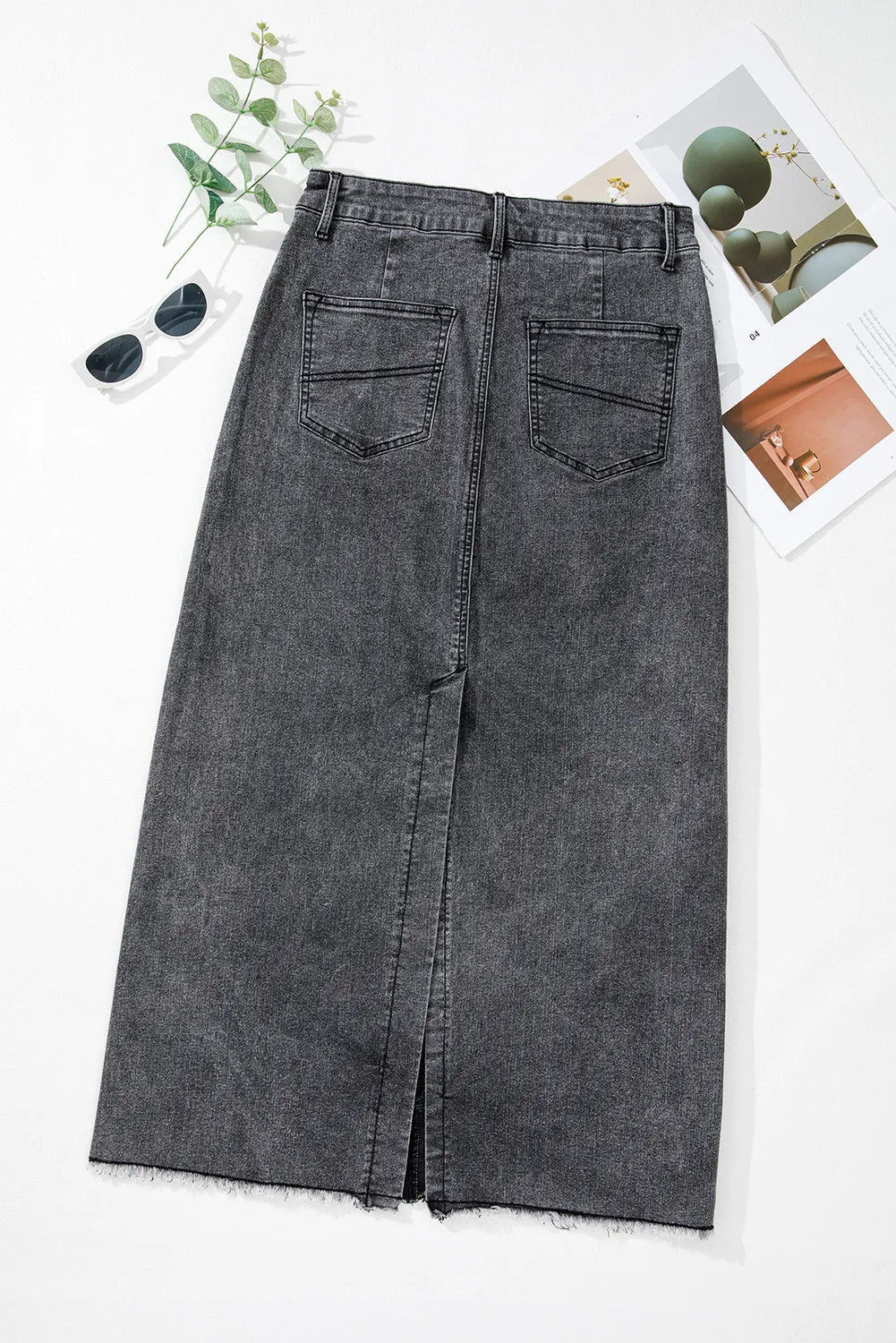 Flat lay rear view of the Zuri Maxi Denim Skirt in Black, showcasing clean seam and pockets.