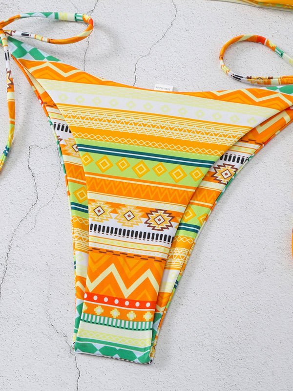 Close-up of ring cut-out and halter tie on orange bikini top.