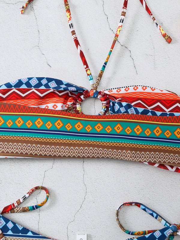 Flat lay of yellow-orange bikini top with vibrant accents. back view