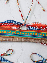Flat lay of yellow-orange bikini top with vibrant accents. back view