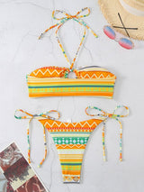 Laid flat multi-stripe bikini set in orange and teal tones.