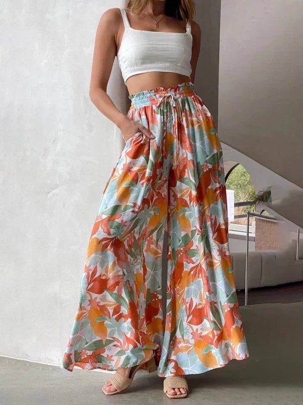 Woman wearing a white top and colorful floral skirt indoors.