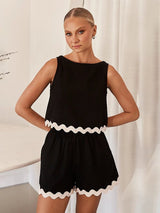 Front view of the sleeveless black crop top and high-waisted shorts.