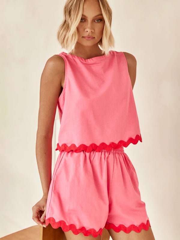 Model wearing the Allessa 2 Piece Shorts Set in pink, showcasing the scalloped hem and sleeveless top.