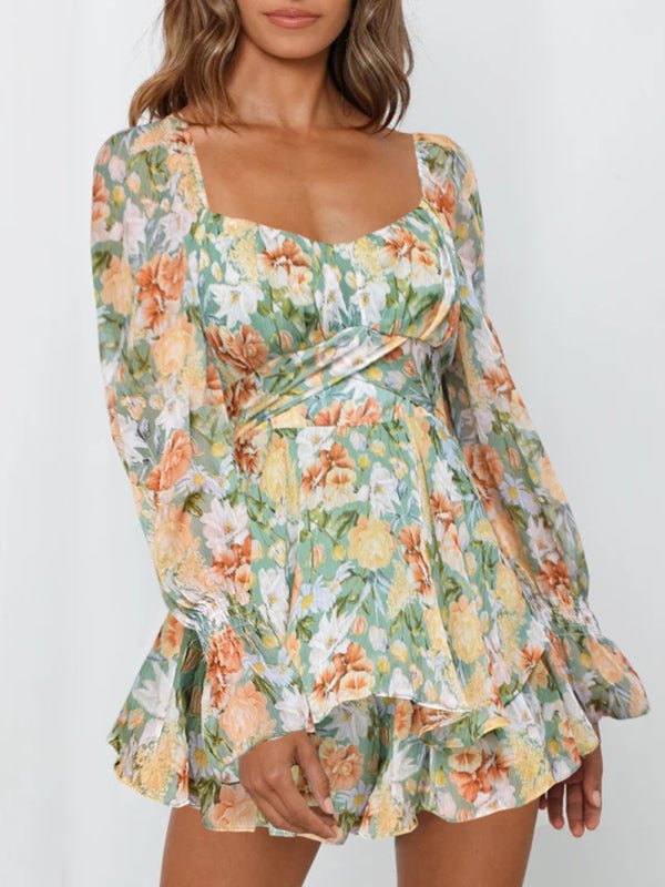 Woman wearing the Belladonna Floral Playsuit in green, standing sideways to show the flow of the skirt.