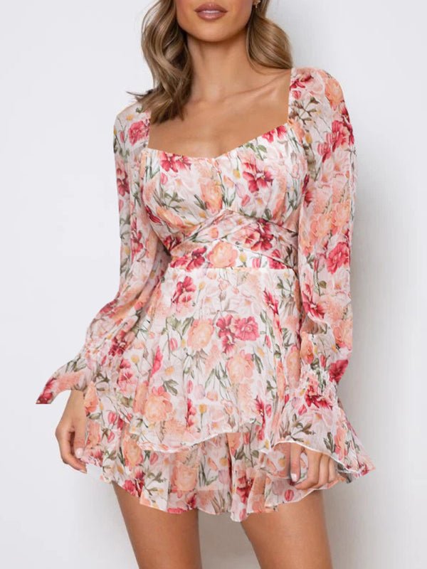 Front view of woman wearing the Belladonna Floral Playsuit in pink, showing layered skirt and ruched bodice.