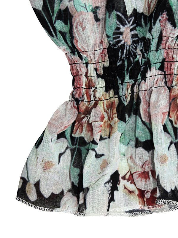 Close-up of the black floral variant, showing lantern sleeve and layered hem.