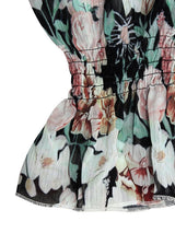 Close-up of the black floral variant, showing lantern sleeve and layered hem.