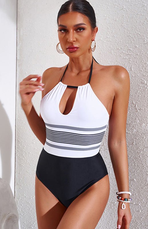 Model wearing the Black & White Cutout Striped Swimsuit with halter neckline and keyhole front.
