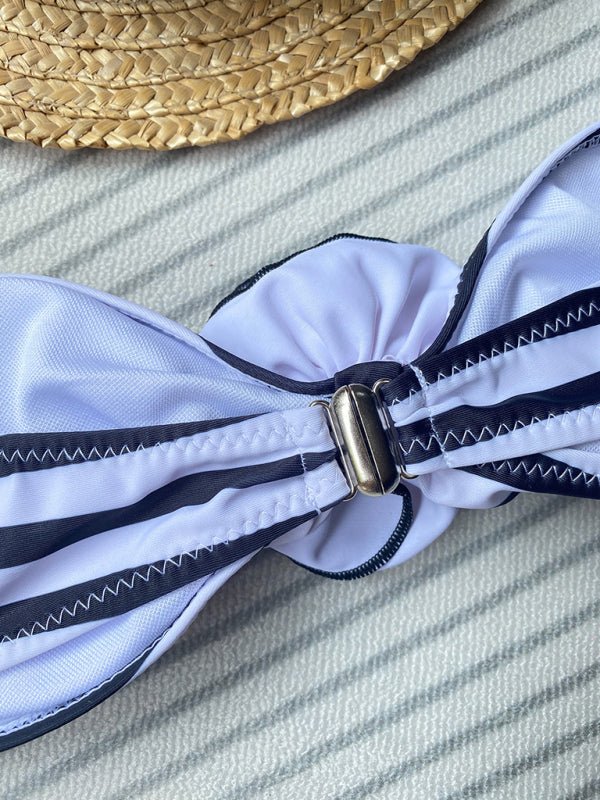 Close-up of striped bandeau bikini top with ruched bow detail.