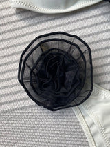 Close-up of floral ruched split design on bikini bottoms in black.