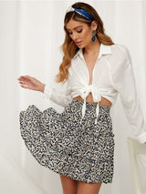 Ruffle Mini Skirt in black and white red dot pattern, paired with a long-sleeve white blouse.