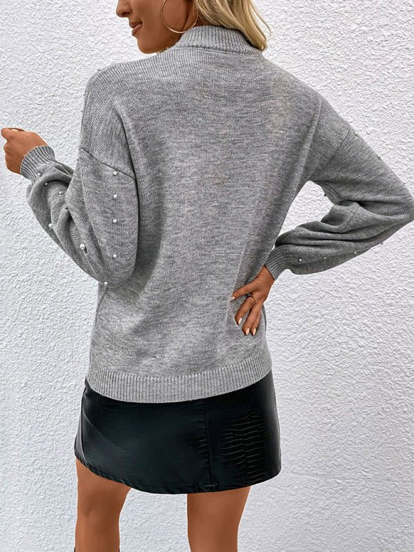 Back view of grey embellished knit sweater showing classic relaxed fit.