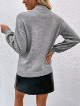 Back view of grey embellished knit sweater showing classic relaxed fit.