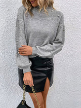 Close-up of front with sparkling embellishment details and soft knit texture.