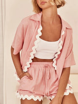 Close-up of scalloped edges and ruched drawstring waist on shorts.