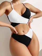 Front view of the bikini in white and black colour block, showing V-neck and ribbed detail.