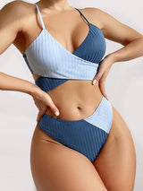 A model in the blue version of the bikini, posing side-on to highlight shape and texture.